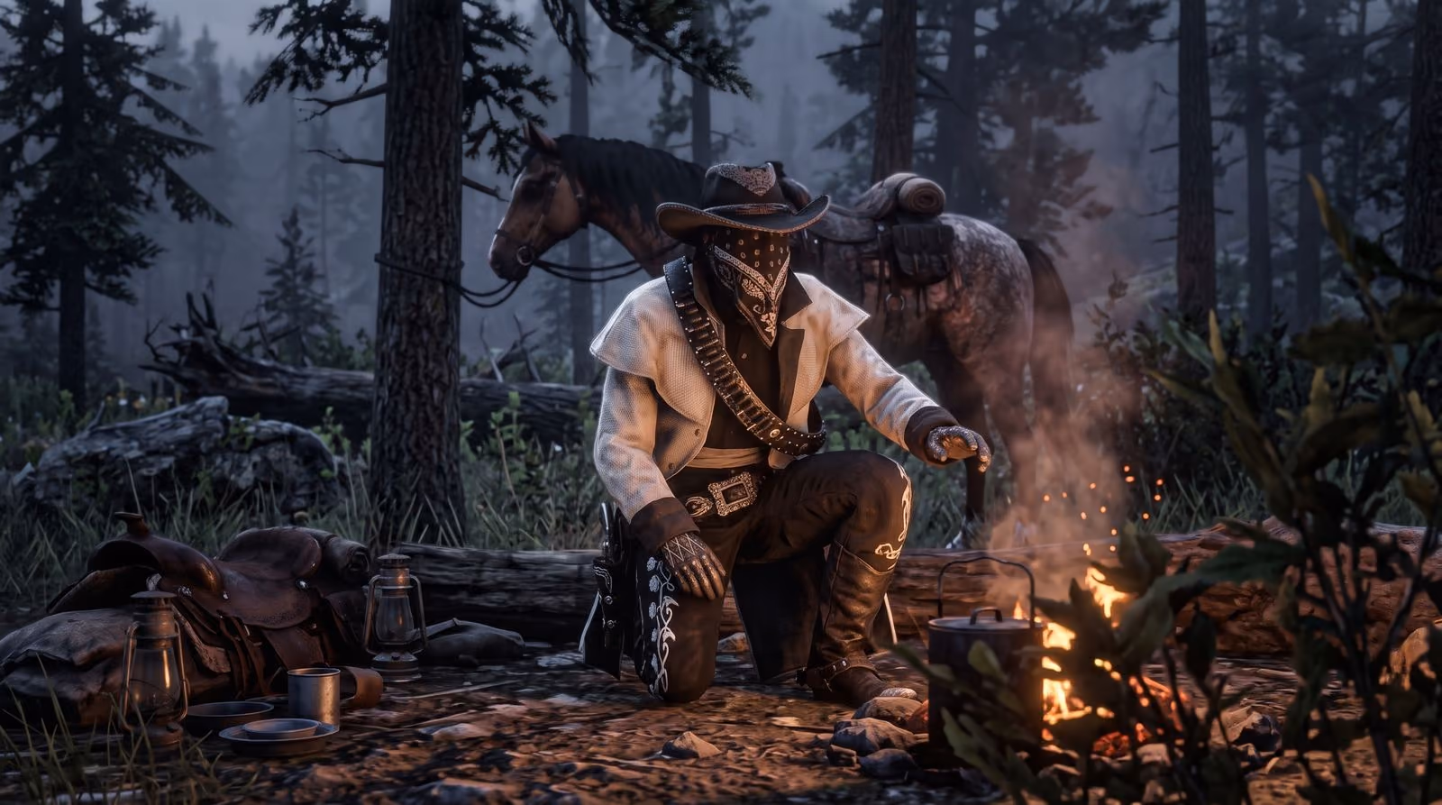 A man in a hat crouches by a campfire at night beside his saddle and horse, the fire the only light on his face.