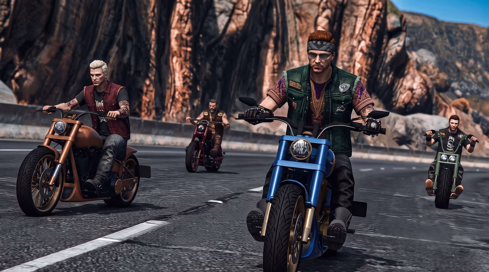 A pack of riders on choppers comes down a canyon road, red rock walls behind them, the lead bike in sharp focus.