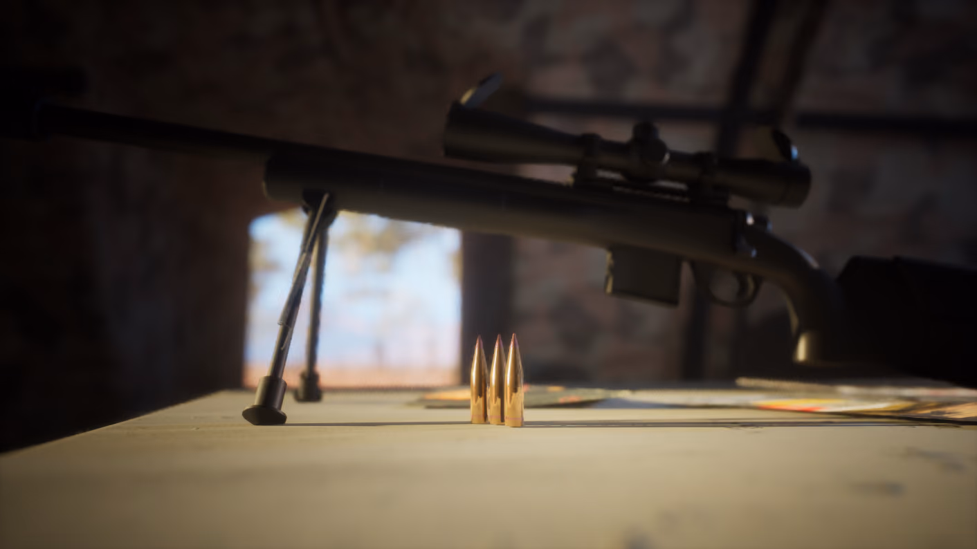 Three brass rounds standing upright and sharp on a trestle table, the rifle behind them thrown out of focus, daylight through the doorway beyond.