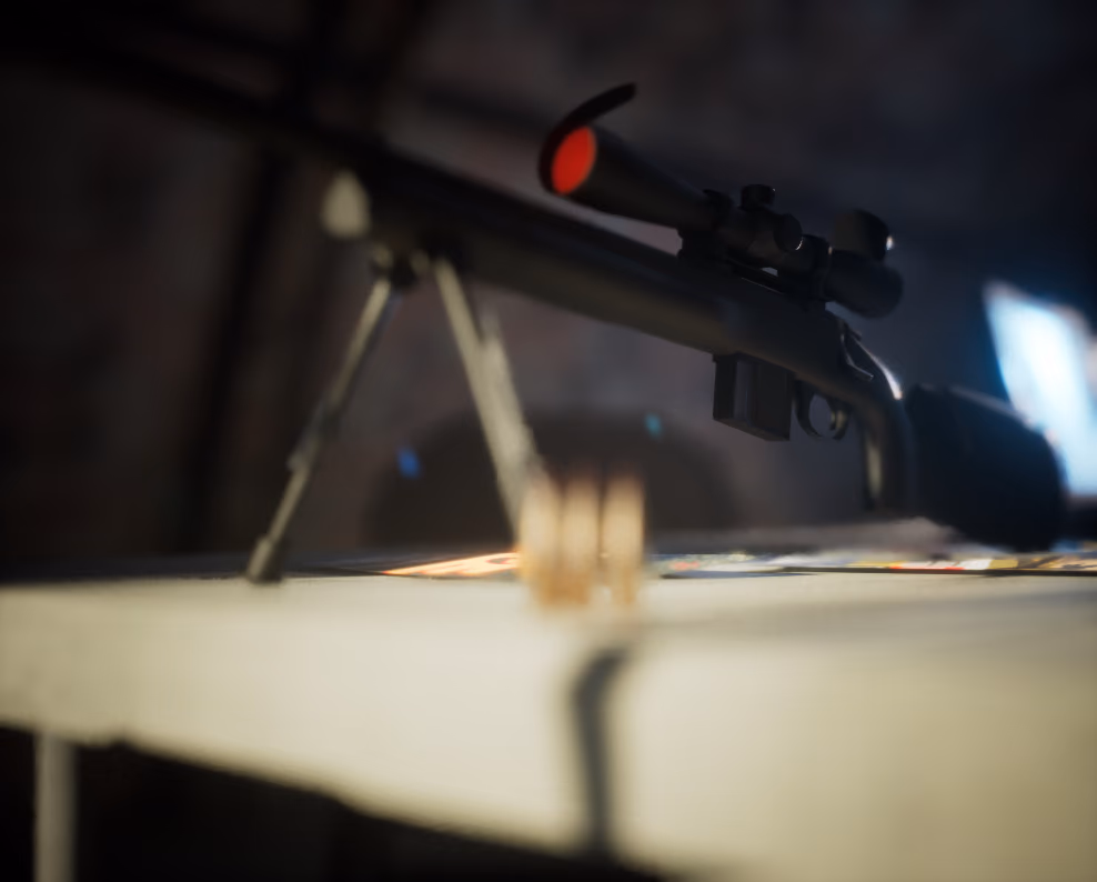 The rifle reduced to a silhouette on its bipod with almost no fill light, the red scope lens and a distant blue screen the only things reading, the rounds barely visible below the barrel.